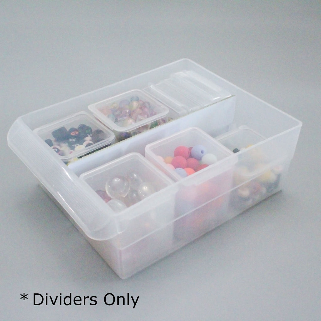 Clear plastic organizer with compartments containing small items on a gray background